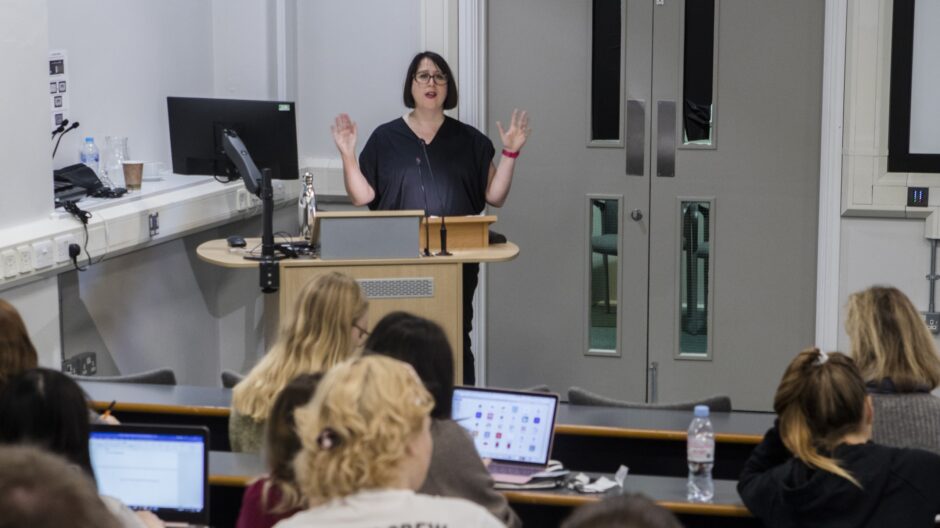 Woman delivering a lecture to students