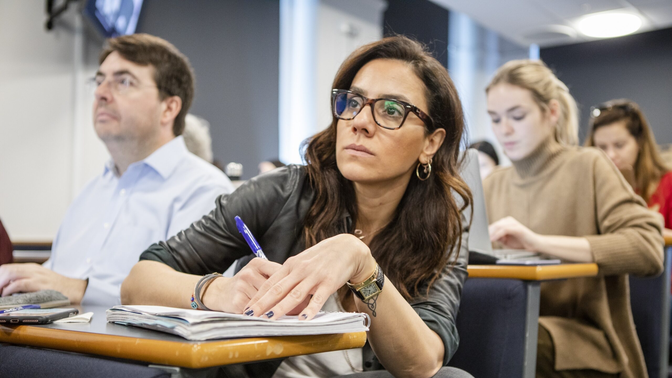 Students take notes in a lecture theatre