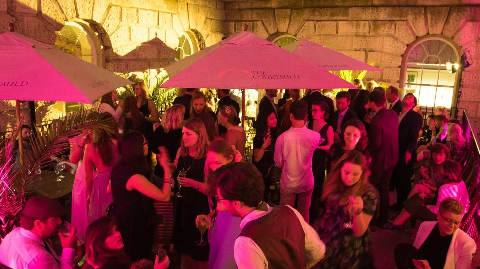 People at night at a social function outdoors at Somerset House.