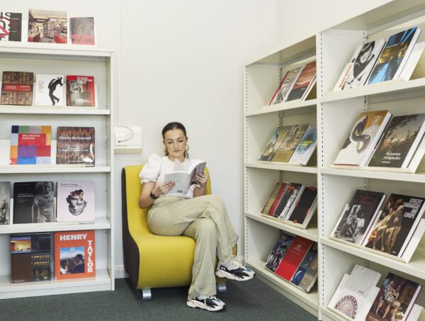 student reading book in library