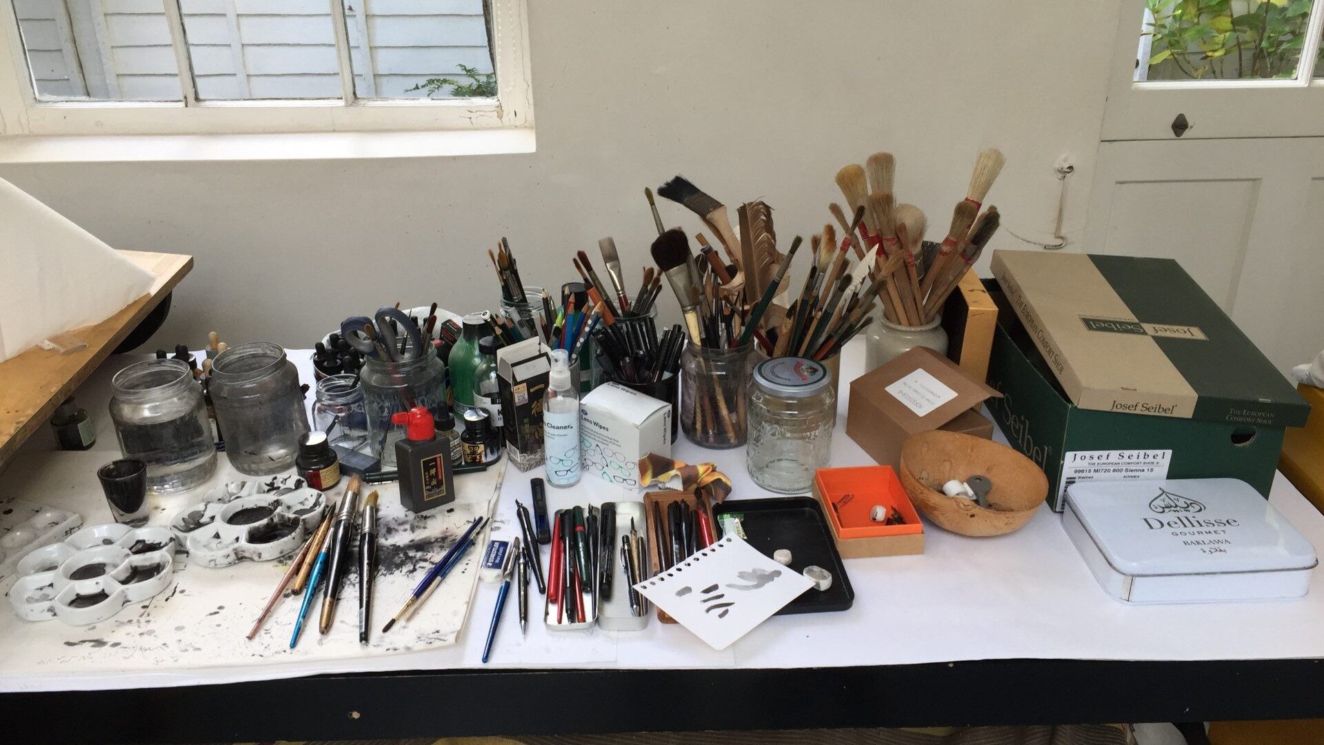 Paint brushes and materials on a table