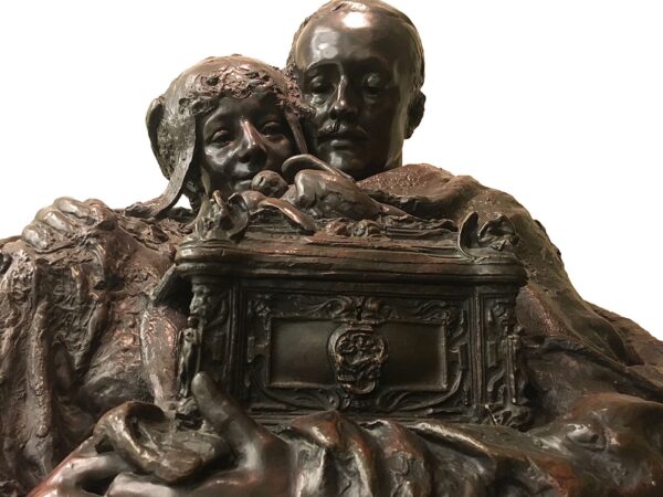 Sculpture of couple holding the casket