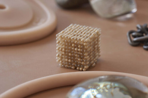 Beaded cube on table