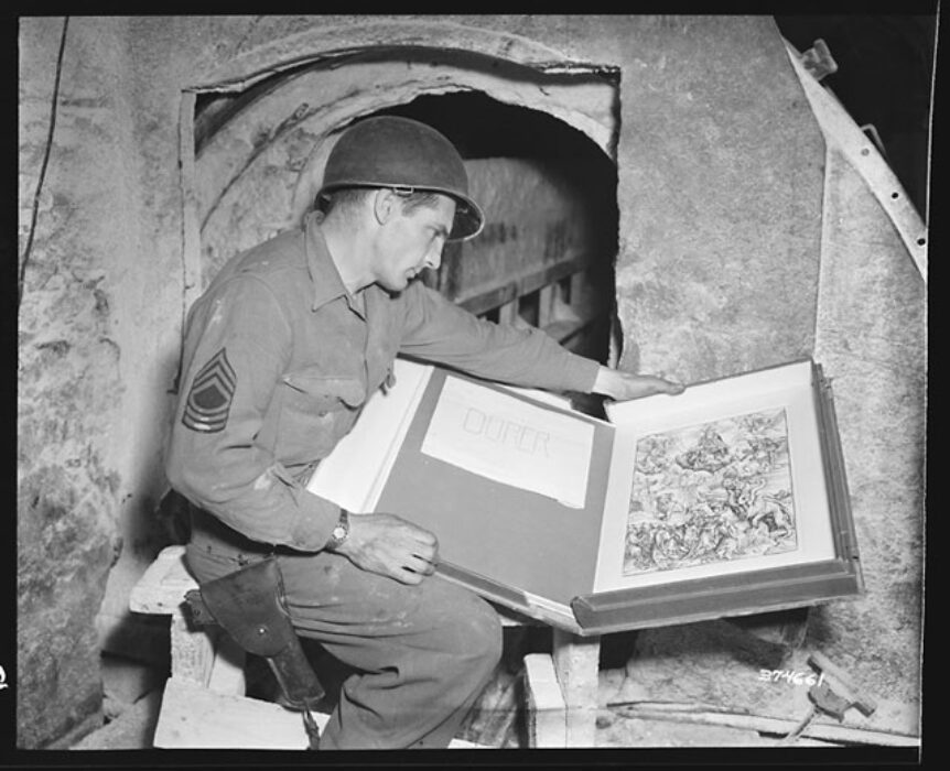 An American GI inspects a looted Durer print in the Merkers salt mine complexines.