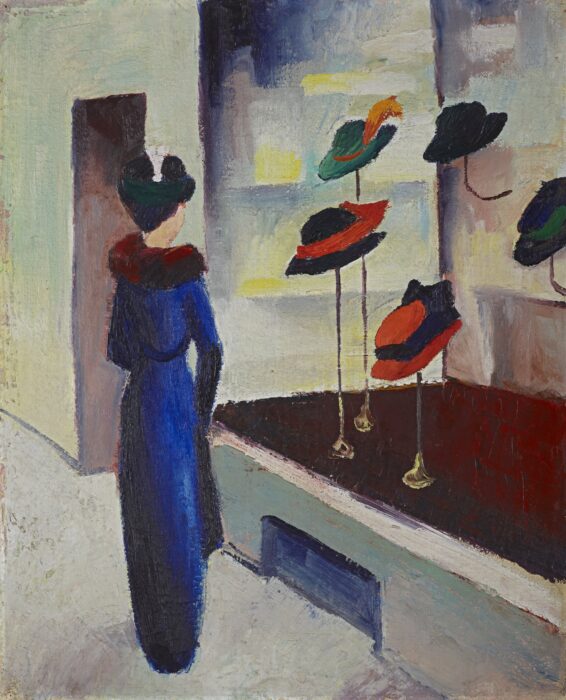 A lady stares into the window of a hat shop.