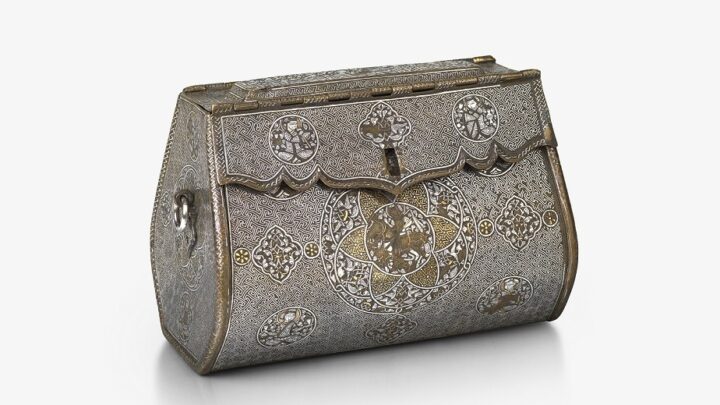 An intricate, oblong-shaped metal bag with front-closure. There are detailed illustrations at regular points across the front, and gold and silver inlays.