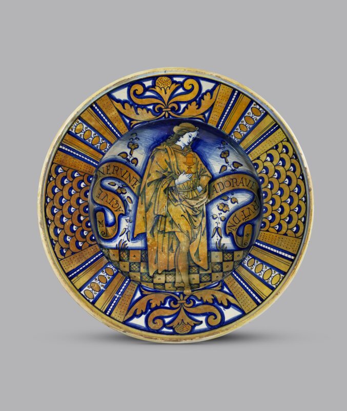This beautifully painted dish shows the close ties between painting and pottery in Umbria, central Italy. The image is based on a detail from a painting by Pietro Vannucci, known as Perugino