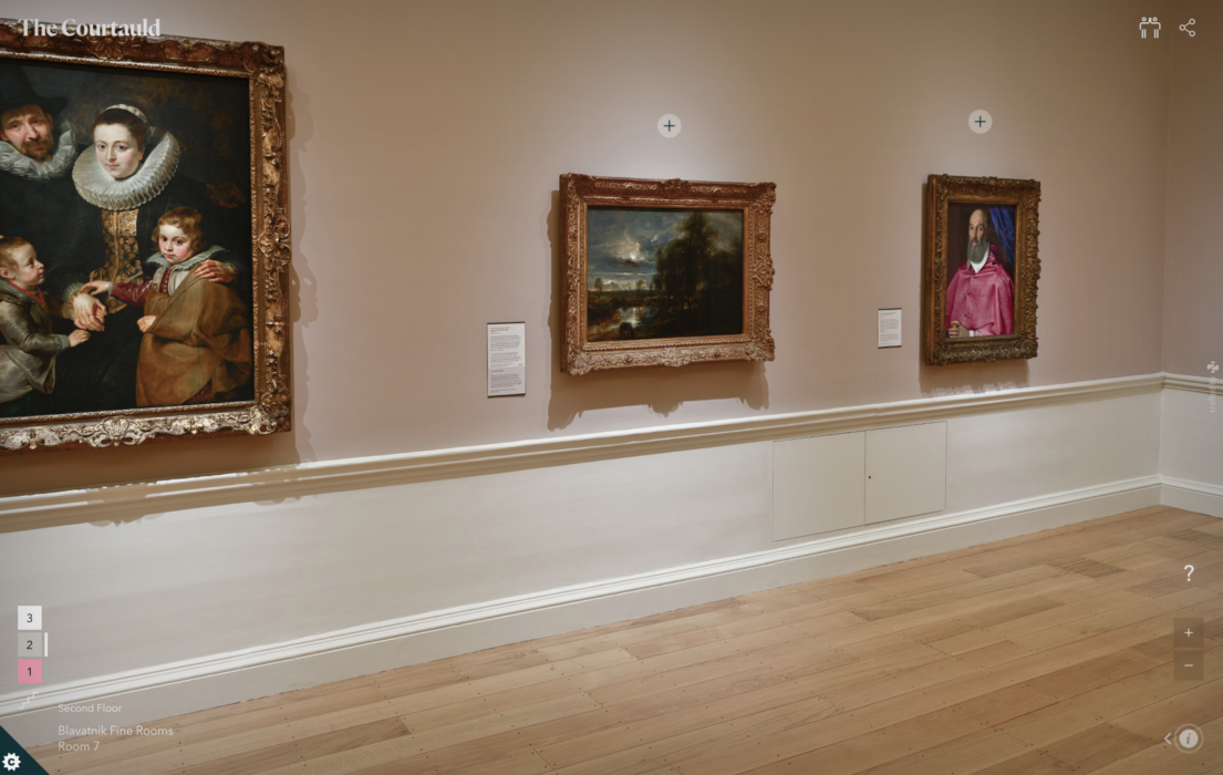 Photo of a wall hung with paintings