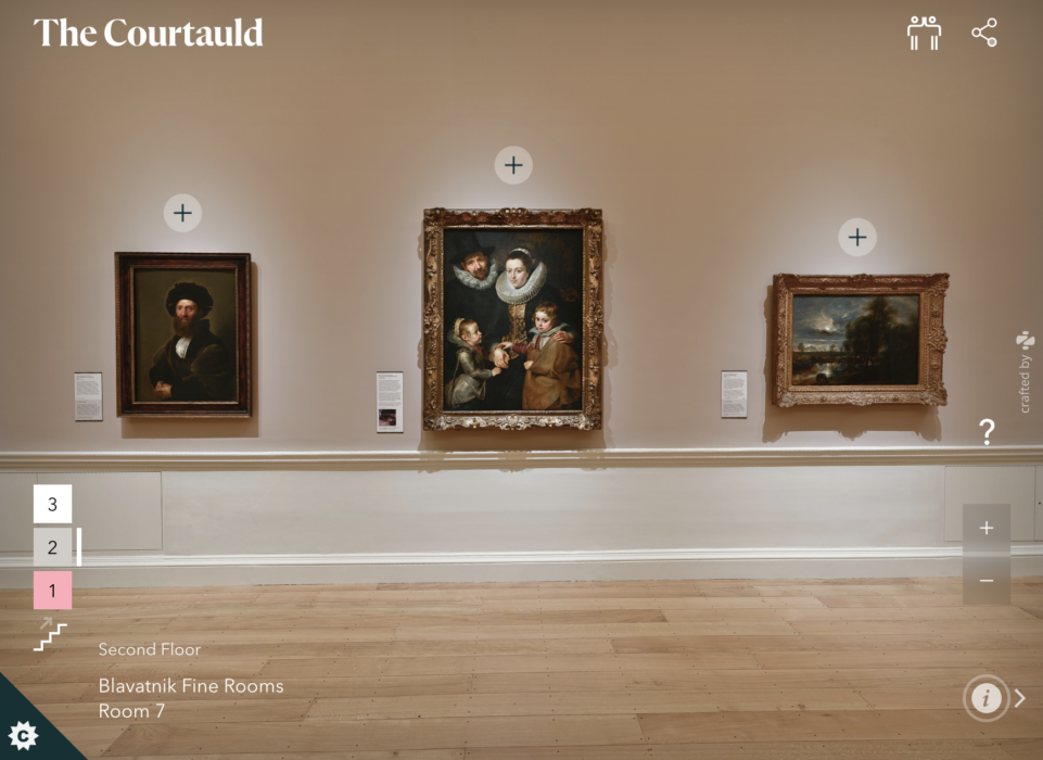 Photo of a wall hung with paintings