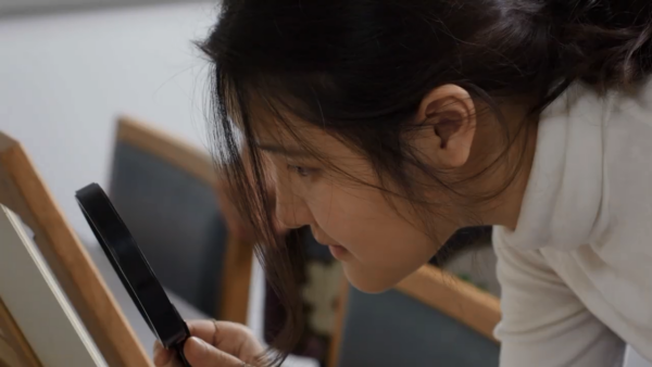 student looking at prints