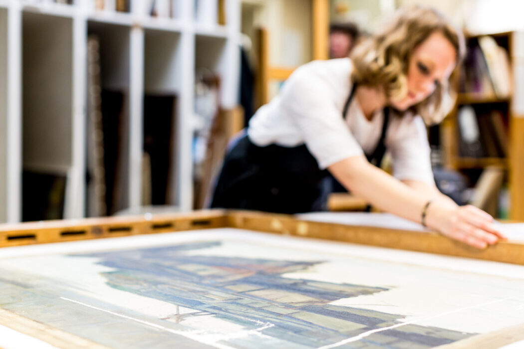 conservaion student assessing the back of a canvas