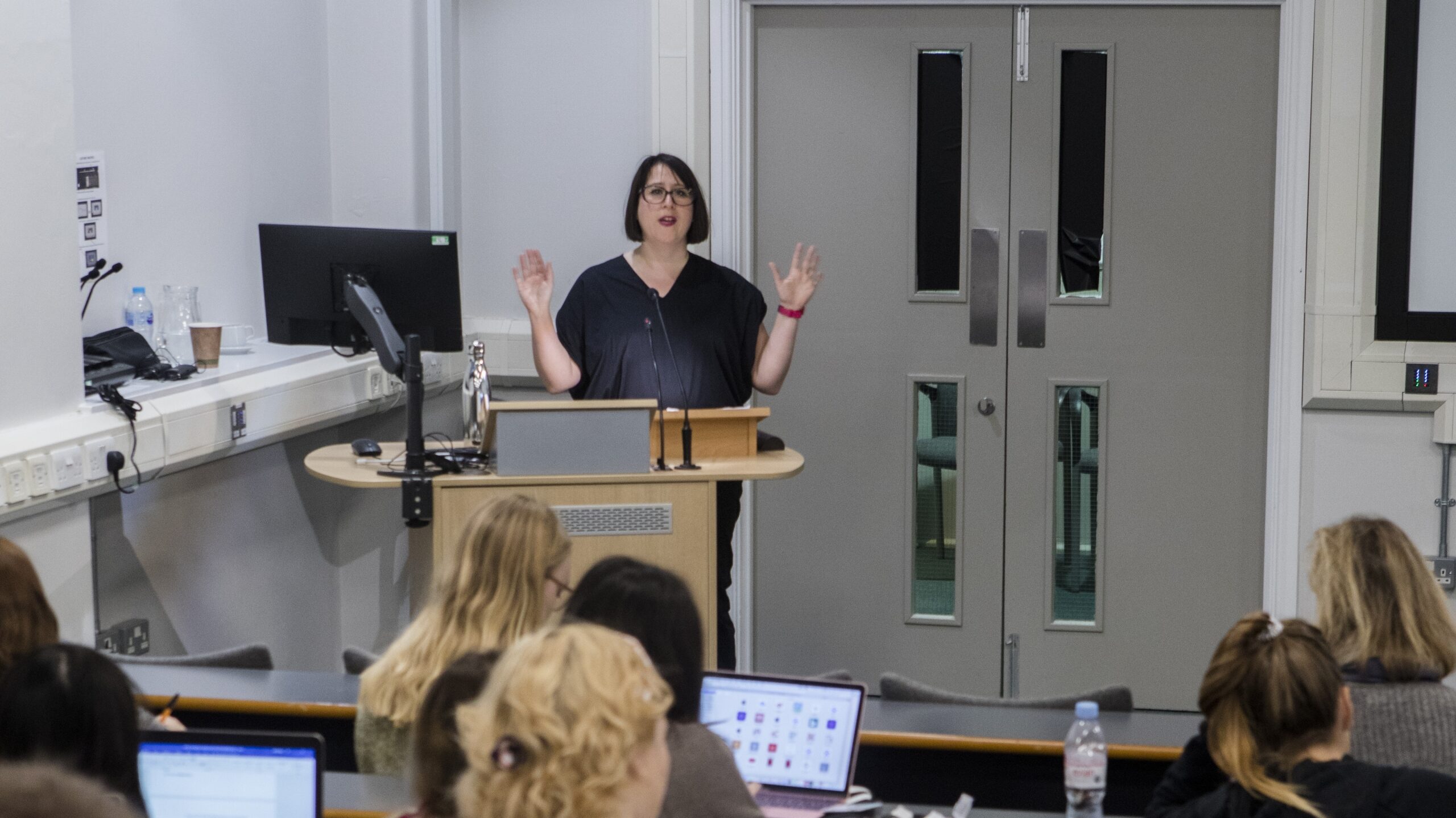 Woman delivering a lecture to students