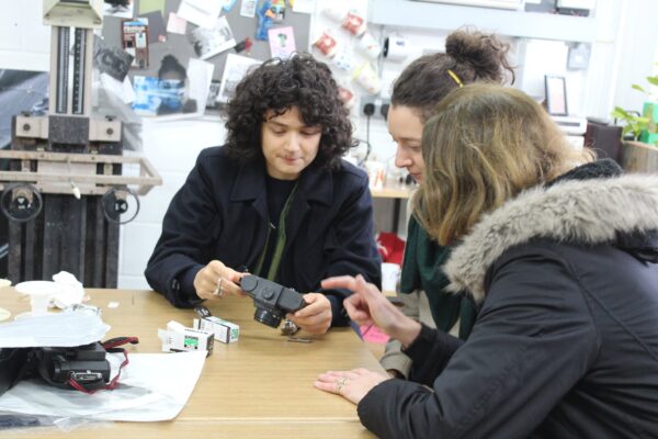 students looking at various film cameras