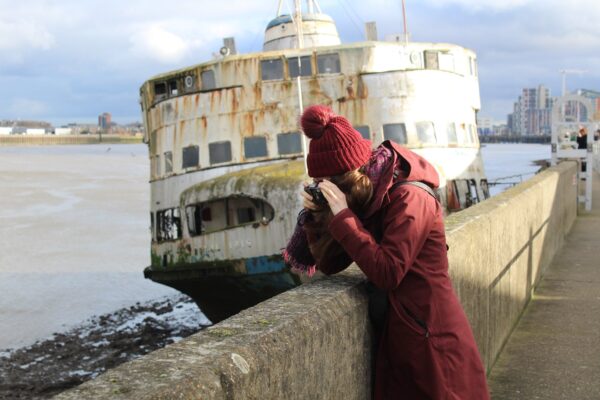 a student taking a photograph of the Thames