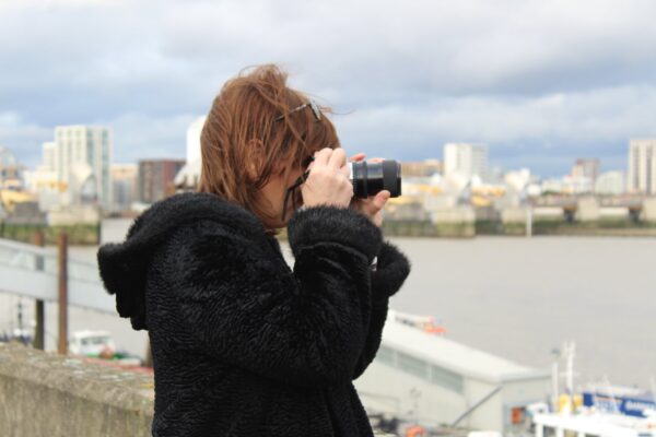 a person taking a photograph of the Thames