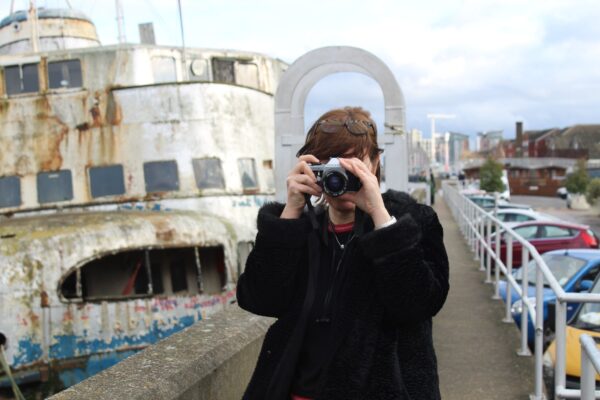 a person taking a photograph, whilst being photographed