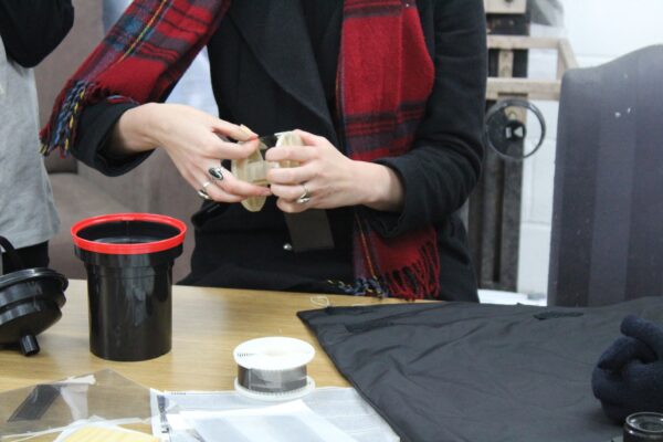 threading a film reel onto a developing reel.