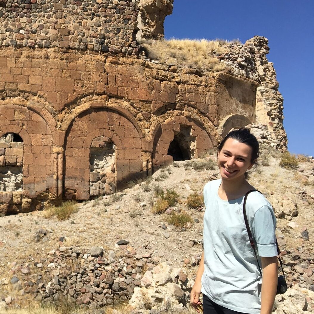 Woman in front of architectural ruins