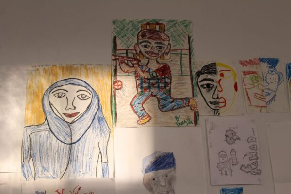 Six portrait drawing attached to a wall