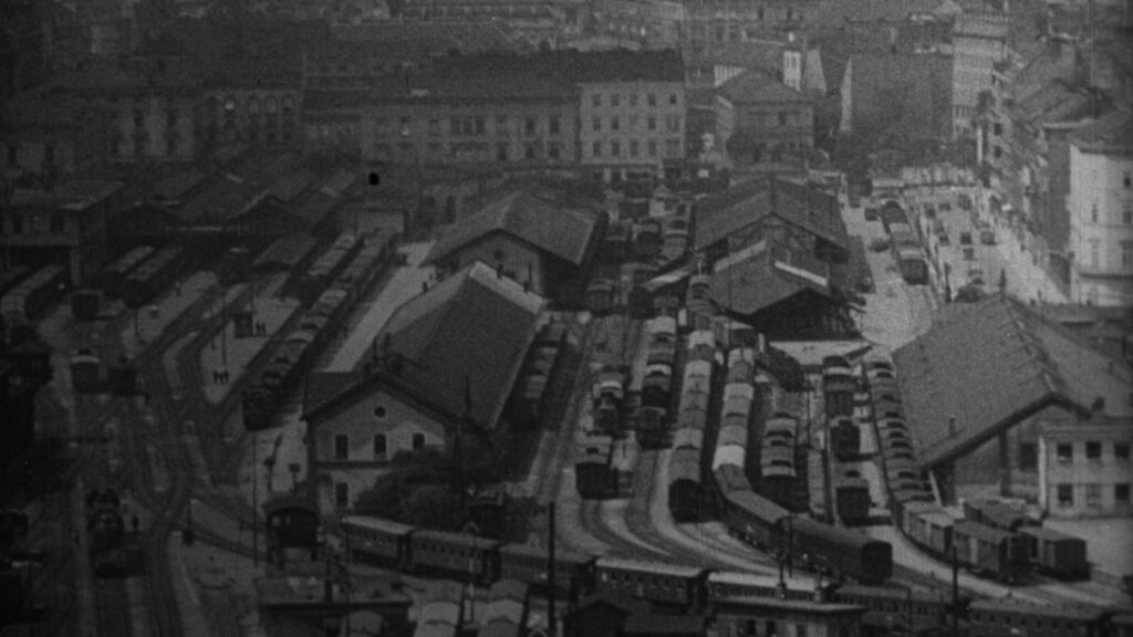 black and white picture of a view from above a train station