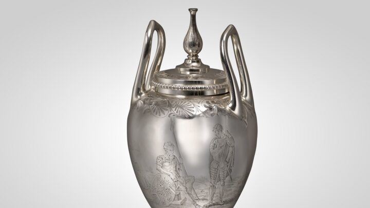 Silver George III condiment vase with two handles and a lid, depicting two figures on the vase