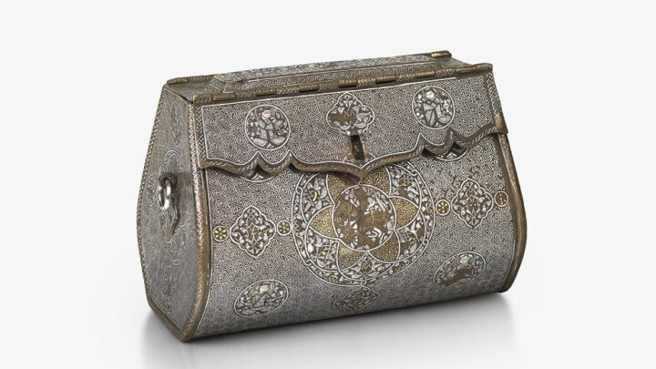 An intricate, oblong-shaped metal bag with front-closure. There are detailed illustrations at regular points across the front, and gold and silver inlays.