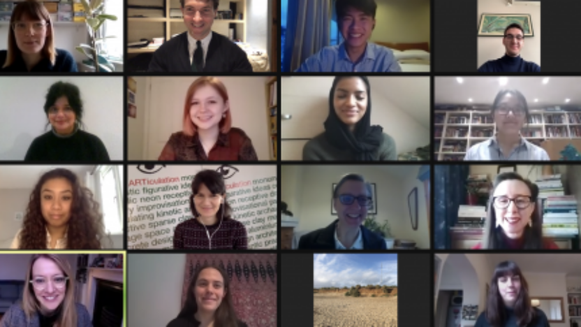 A screenshot of a zoom meeting, with sixteen people visible, smiling.