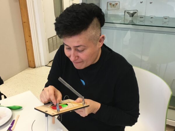 a student playing a sound board