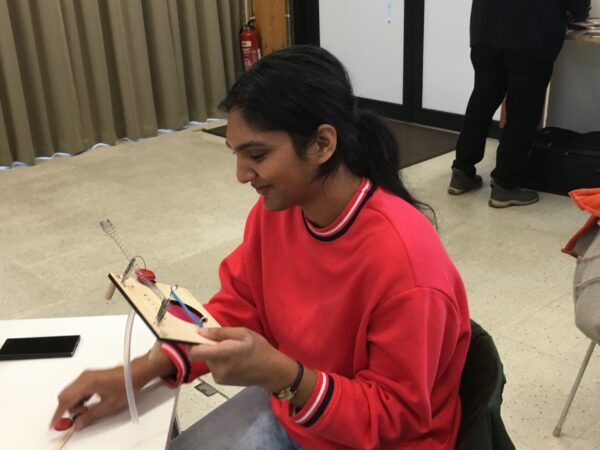 a student playing a sound board
