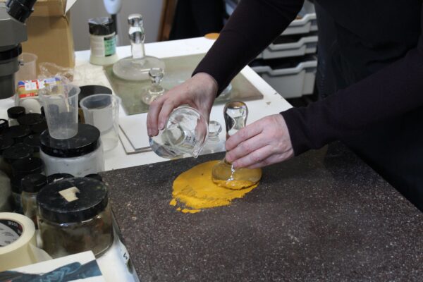 making yellow pigment with a glass pestle