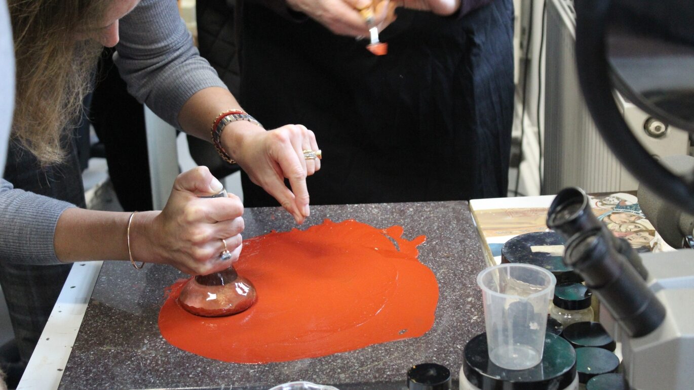 students learning how to grind pigments into oil paint