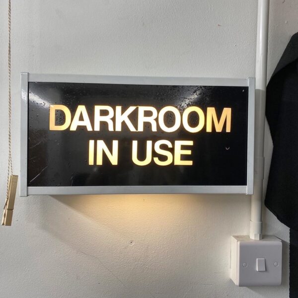 a dark room in use sign