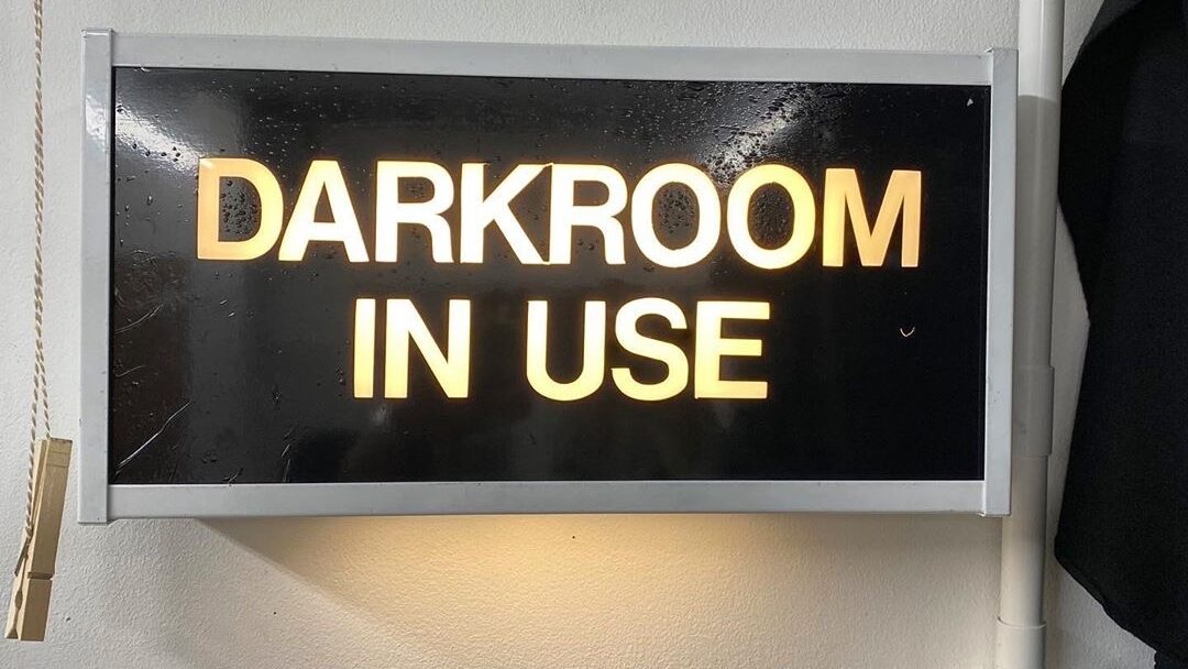 a dark room in use sign