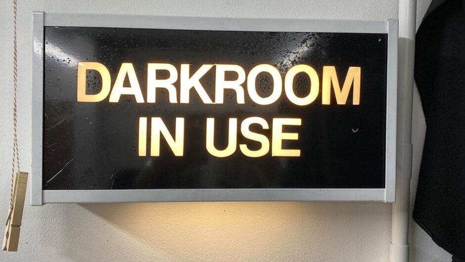 a dark room in use sign