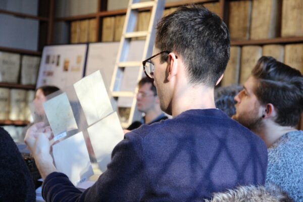 a student looking at samples of velum