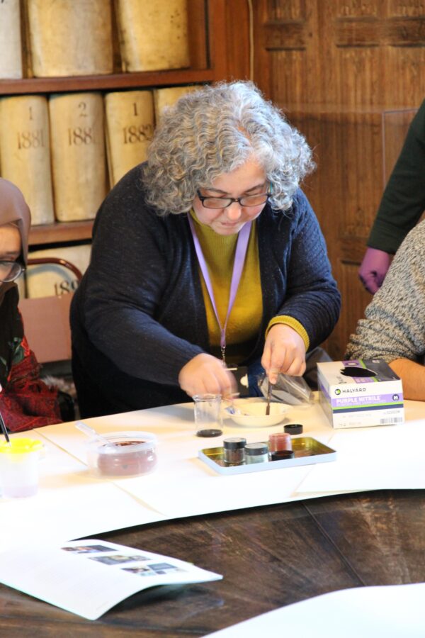 a woman mixing pigments