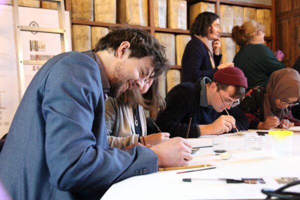 students trying out fresh mixed pigments on velum