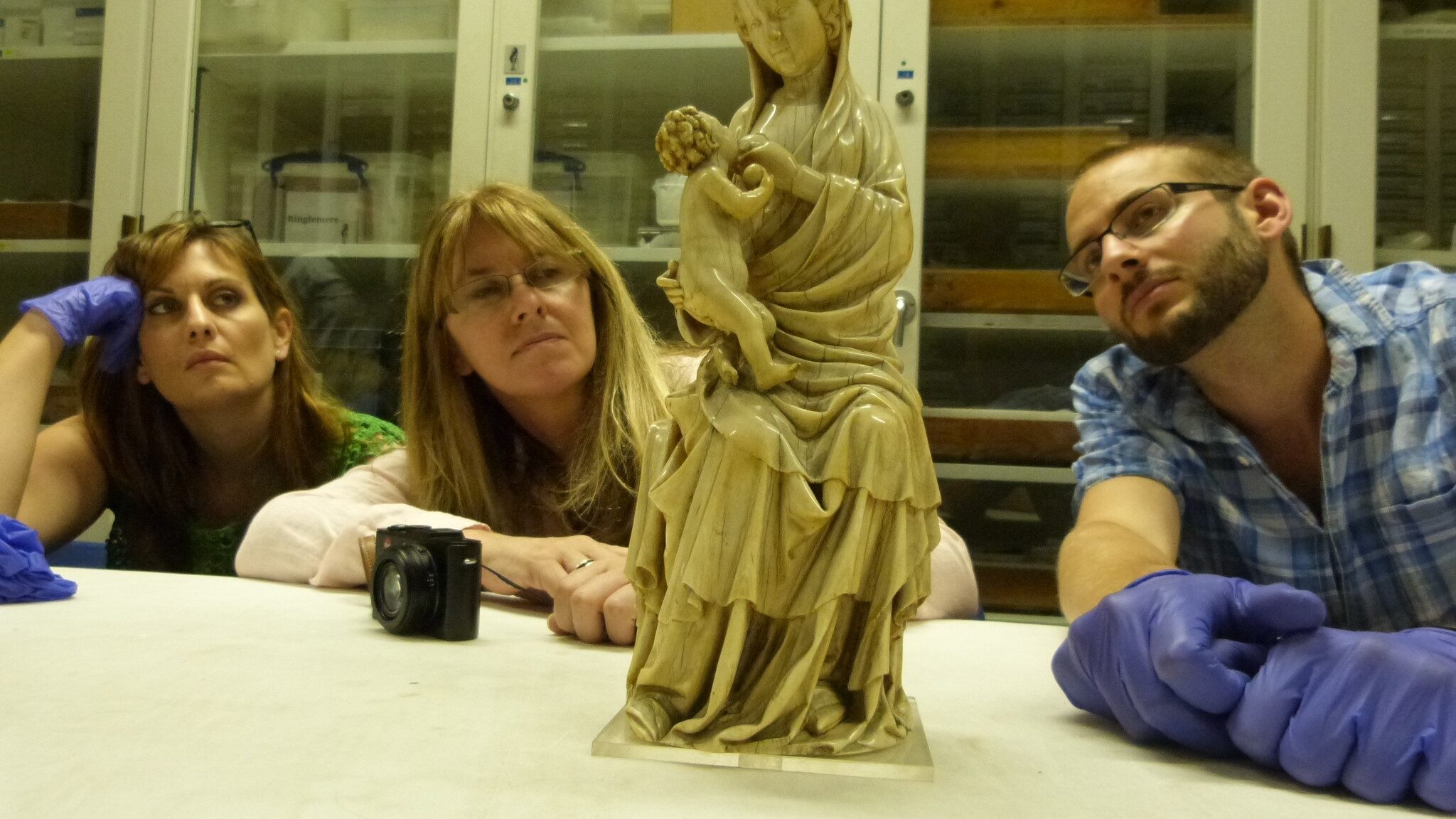 photograph of three courtauld lecturers handling a medieval ivory object at the British Museum