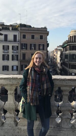 Woman standing on a bridge smiling