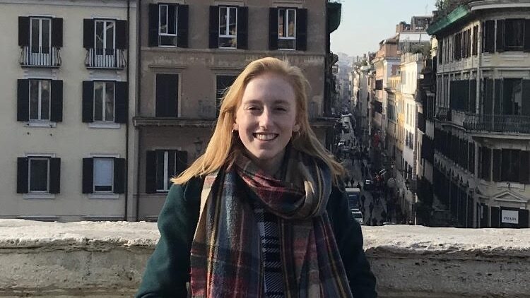 Woman standing on a bridge smiling