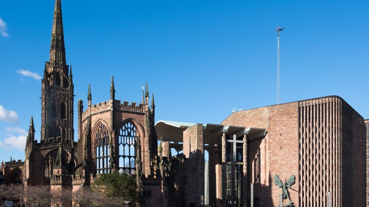 Photograph of Coventry Cathedral against a blue sky