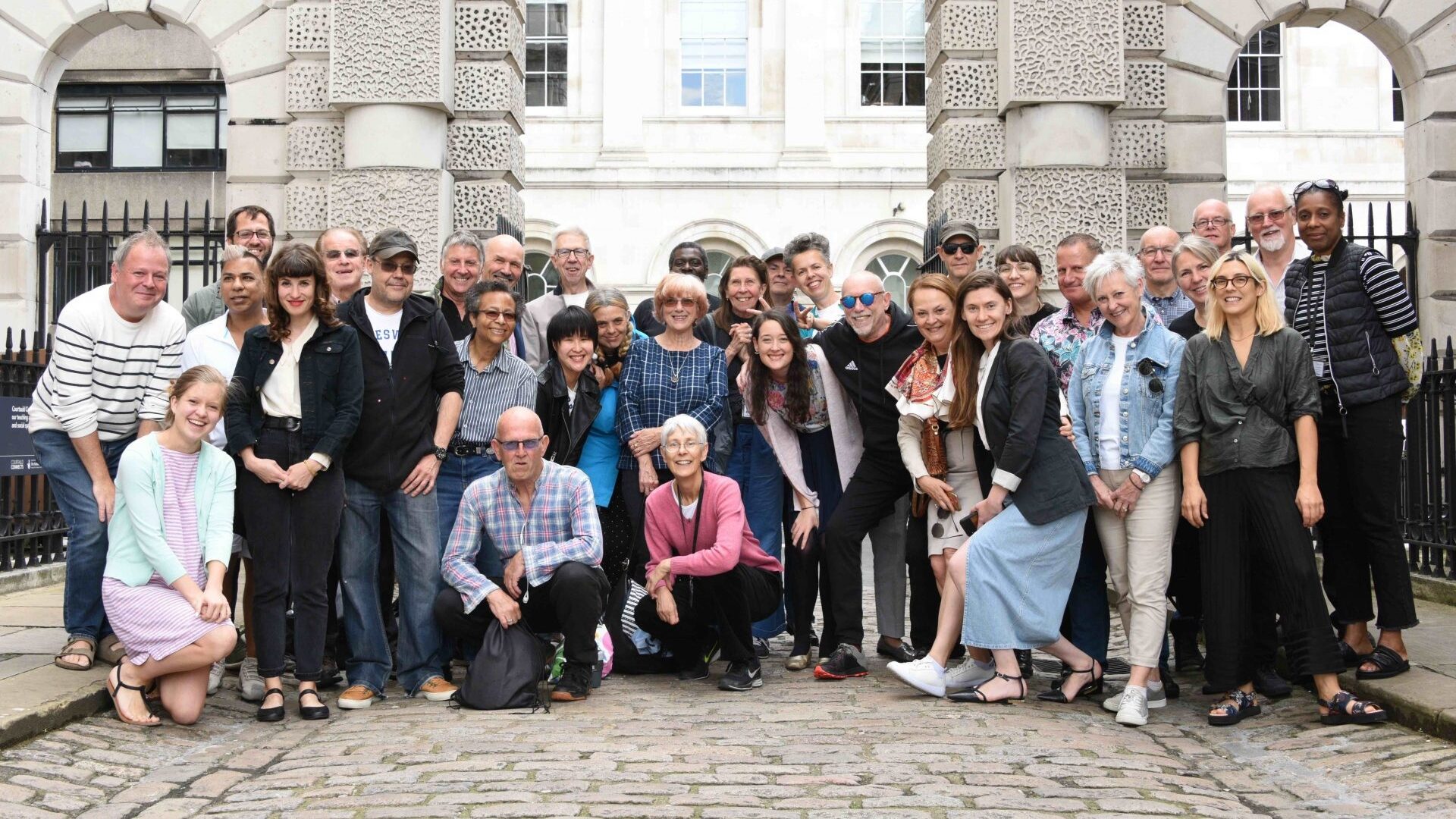group of volunteers stood together infront of the courtauld at somerset house