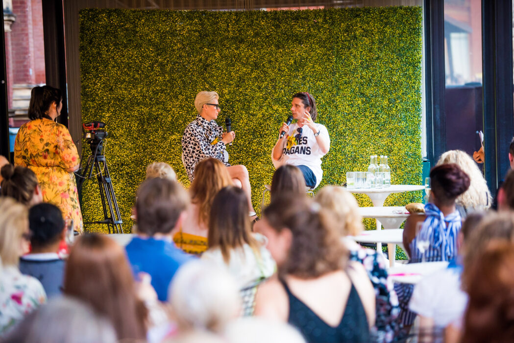 Two people in conversation on stage.