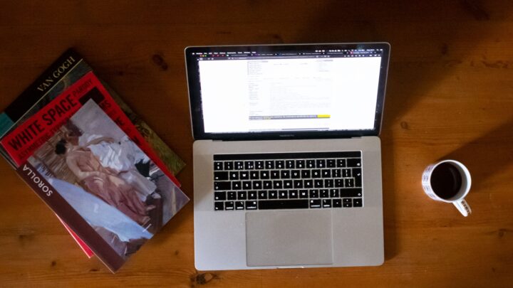Art books on table with laptop