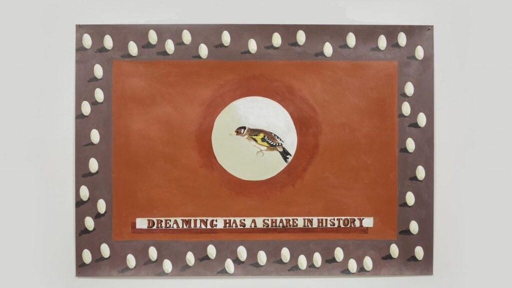 Painting showing a small bird in a central white circle above the words 'Dreaming Has a Share in History' with a grey border showing small eggs