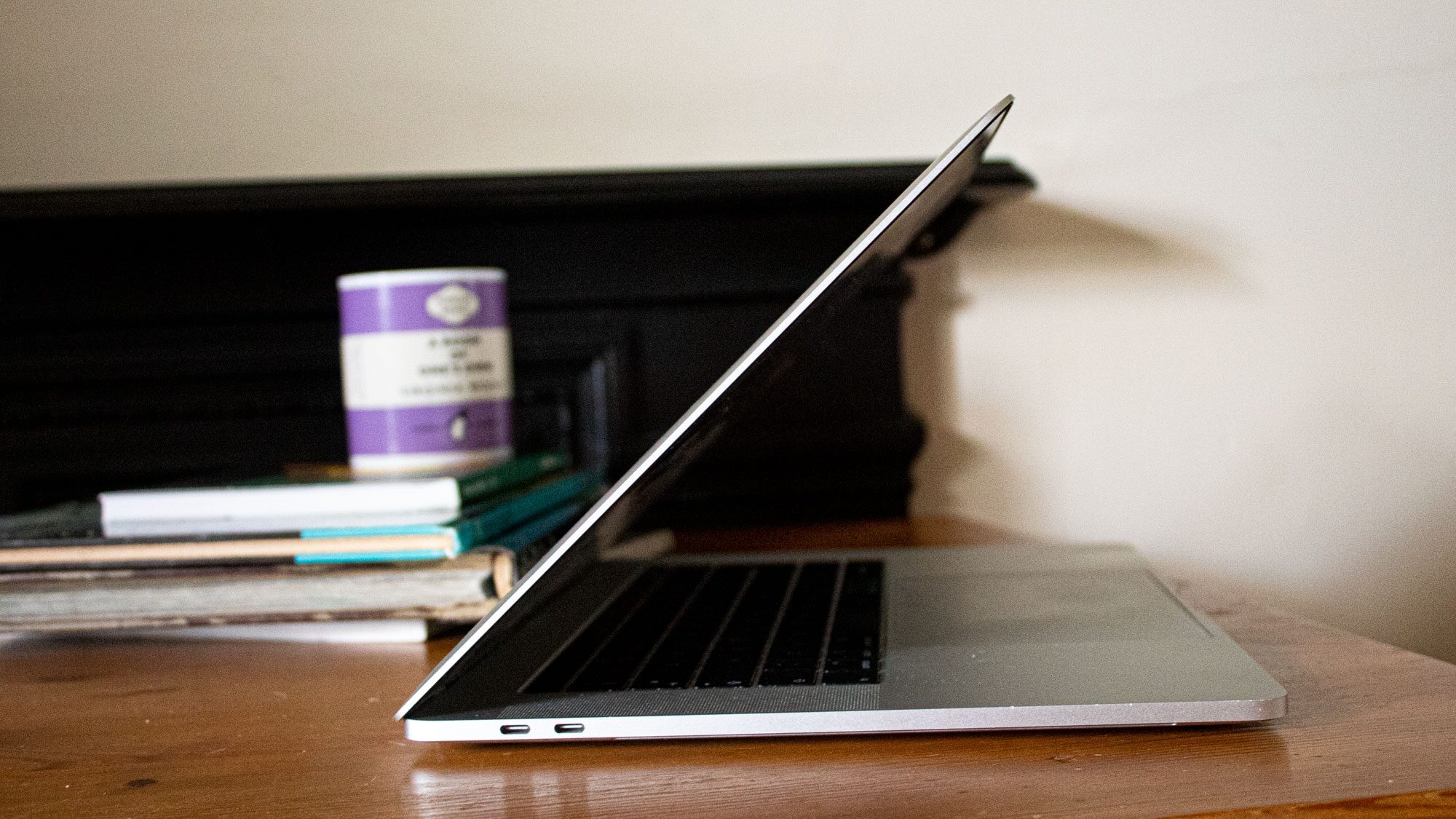 laptop on table with books