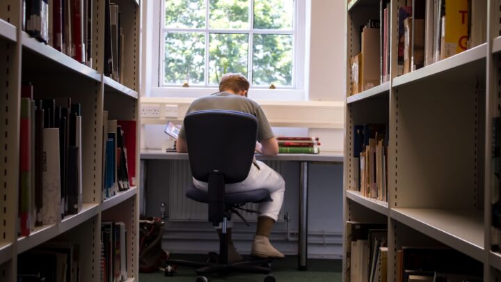 student reading in the library
