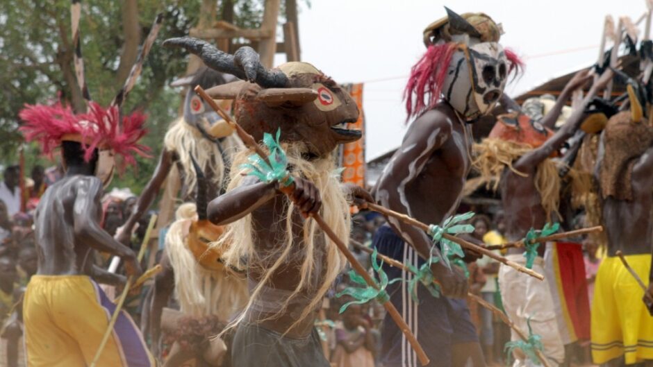 mask wearing dancers from the project Opera Village Africa