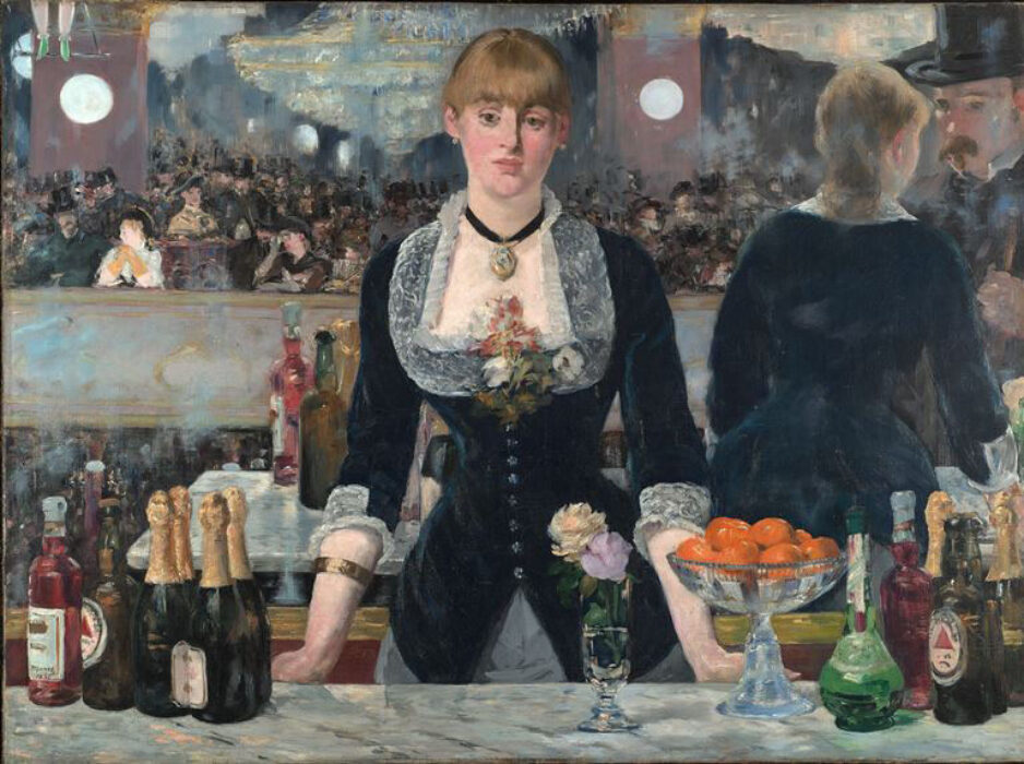 A woman standing behind a bar facing straight ahead.