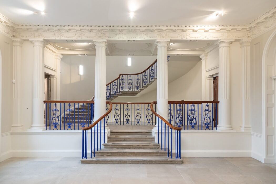 View of staircase with stone steps and blue railings